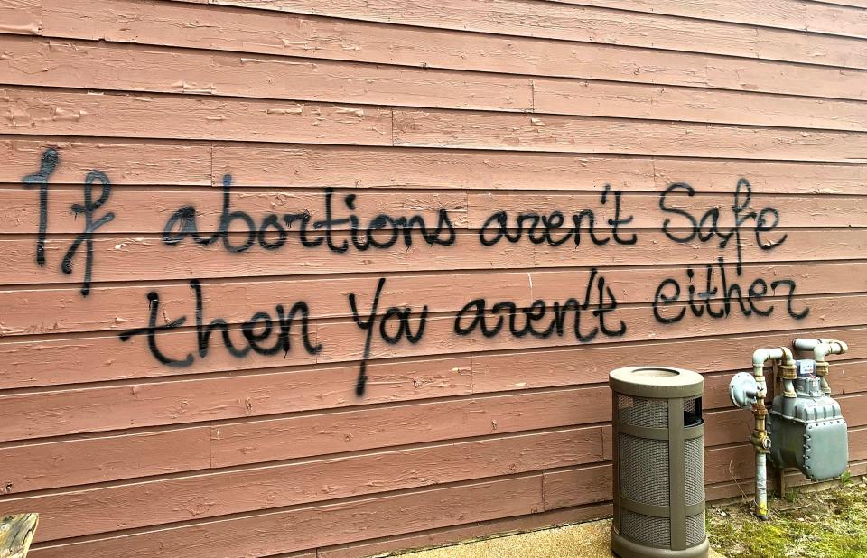 Threatening graffiti is seen on the exterior of Wisconsin Family Action offices in Madison, Wis., on Sunday, May 8, 2022.