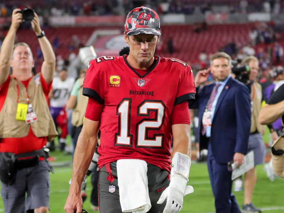 Tom Brady walks off the field after a loss against the Baltimore Ravens.