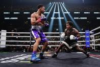 Rolando Romero, left, fights Gervonta Davis during the fifth round of a WBA lightweight championship boxing bout early Sunday, May 29, 2022, in New York. Davis won in the sixth round. (AP Photo/Frank Franklin II)