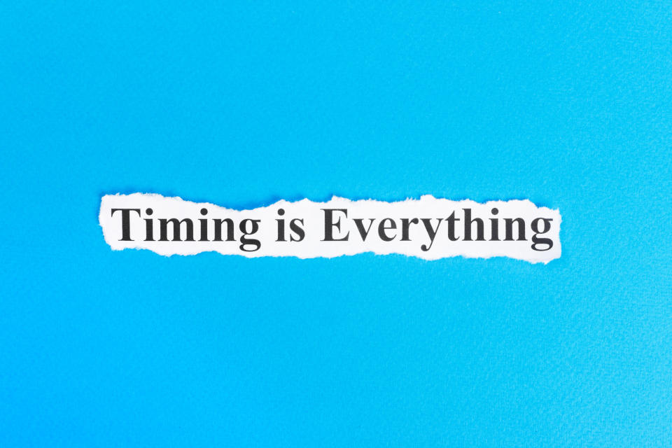 A torn piece of white paper is set against a blue background and it has the words "Timing is Everything" printed on it. 
