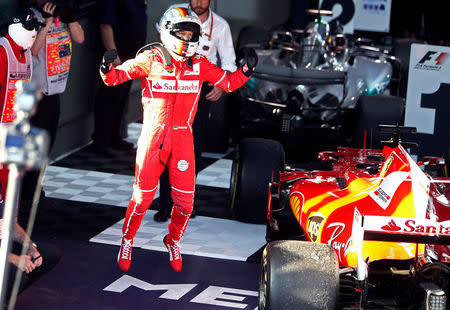 Formula One - F1 - Australian Grand Prix - Melbourne, Australia - 26/03/2017 - Ferrari driver Sebastian Vettel of Germany celebrates after winning the Australian Grand Prix. REUTERS/Brandon Malone