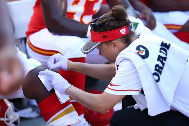 <p>Courtesy of Chiefs.com</p> Tiffany Morton working on the sidelines during a Chiefs game