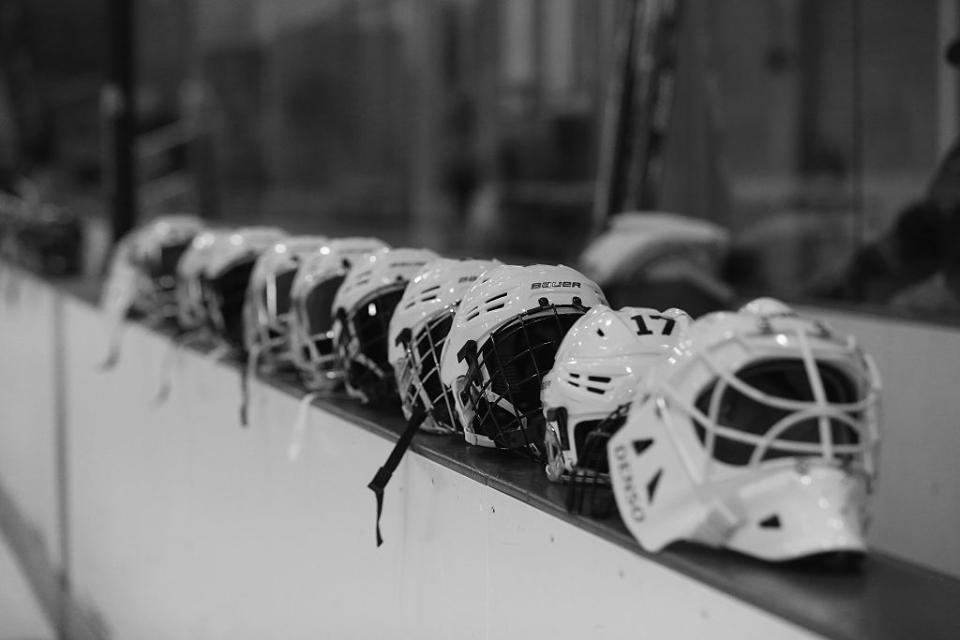 BROOKLYN, NY - OCTOBER 25: (EDITORS NOTE: Image has been converted to black and white.) helmets belonging to the New York Riveters of the National Womens Hockey League are placed on the boards prior to the game against the Connecticut Whale at the Aviator Sports and Event Center on October 25, 2015 in Brooklyn borough of New York City. (Photo by Bruce Bennett/Getty Images)