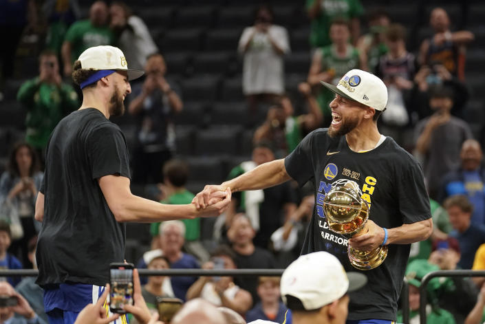Golden State Warriors guard Stephen Curry, right and Golden State Warriors guard Klay Thompson celebrate after defeating the Boston Celtics in Game 6 to win basketball's NBA Finals, Thursday, June 16, 2022, in Boston. (AP Photo/Steven Senne)