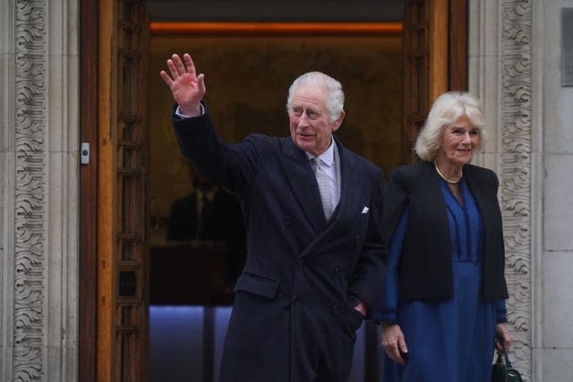 The King waves as he leaves hospital with Camilla