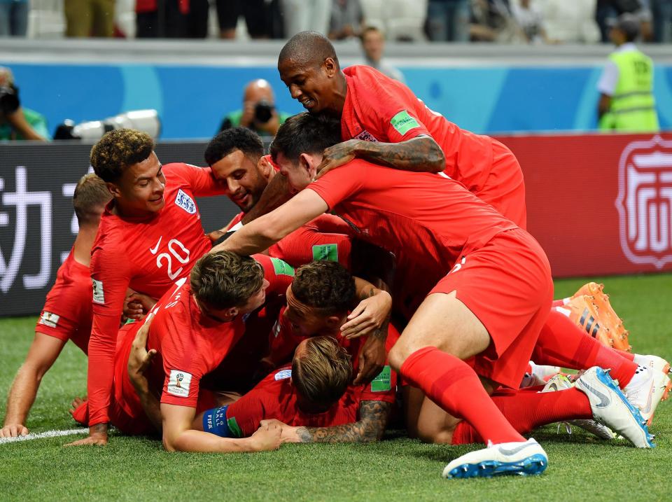 <p>Pile in: The Three Lions celebrate Harry Kane’s opening goal. (AP) </p>