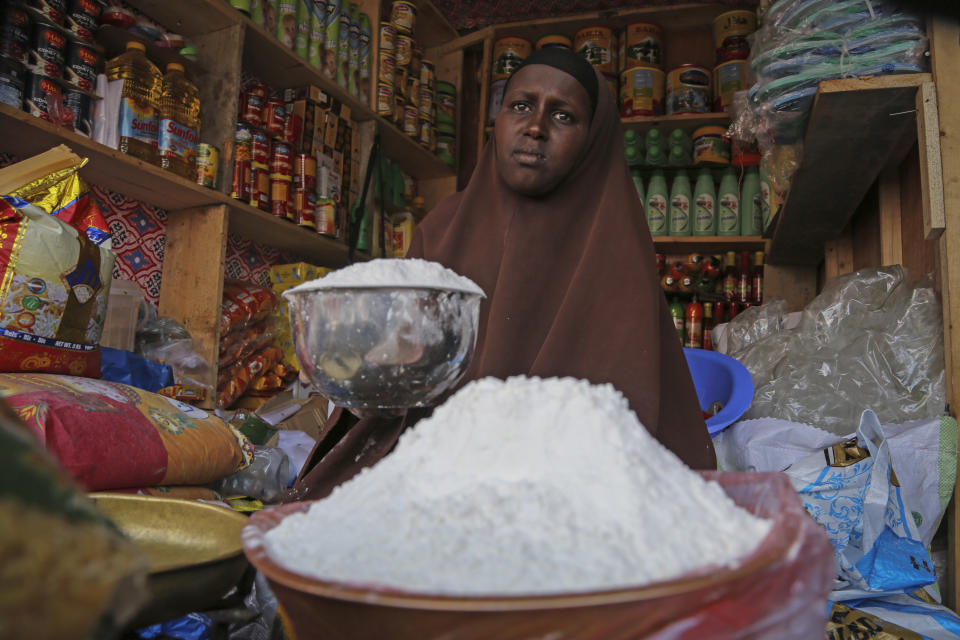 FILE - A shopkeeper sells wheat flour in the Hamar-Weyne market in the capital Mogadishu, Somalia Thursday, May 26, 2022. War has been a catastrophe for Ukraine and a crisis for the globe. One year on, thousands of civilians are dead, and countless buildings have been destroyed. Hundreds of thousands of troops have been killed or wounded on each side. Beyond Ukraine’s borders, the invasion shattered European security, redrew nations’ relations with one another and frayed a tightly woven global economy. (AP Photo/Farah Abdi Warsameh, File)