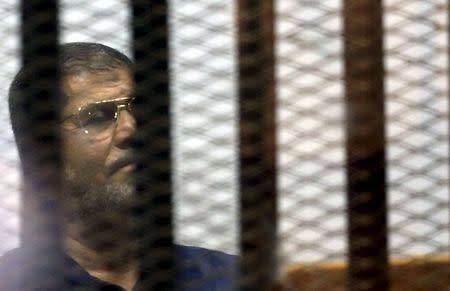 Former Egyptian President Mohamed Mursi looks on during his appearance in court on the outskirts of Cairo, Egypt, June 2, 2015. REUTERS/Amr Abdallah Dalsh
