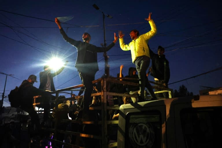 Palestinians celebrate in Rafah, in the southern Gaza Strip, after Hamas announced it accepted a truce proposal (-)