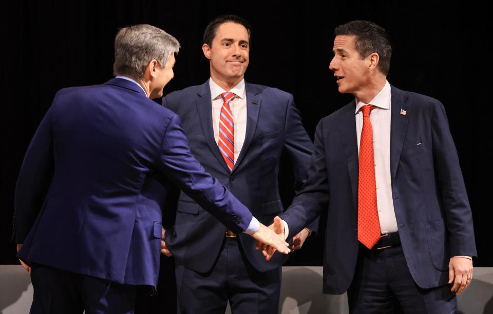 State Sen. Matt Dolan, Secretary of State Frank LaRose and businessman Bernie Moreno greet each other before a primary debate in Findlay on Feb. 19.