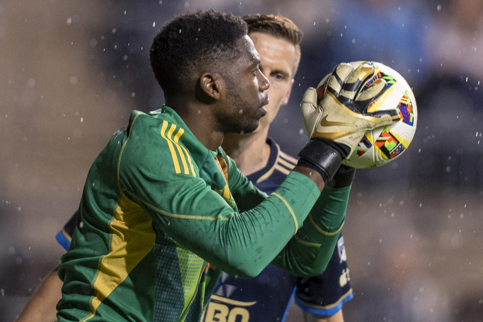 Toronto FC's Sean Johnson, left, makes a save next to Philadelphia Union's Jack Elliott during the second half of an MLS soccer match Wednesday, May 29, 2024, in Chester, Pa. (AP Photo/Chris Szagola)