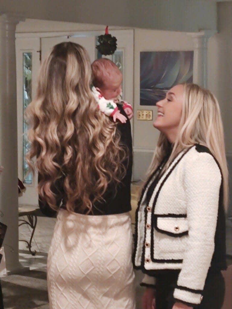 Allie LaForce holds son Jacob while her sister, Dr. AuBree LaForce, looks on.