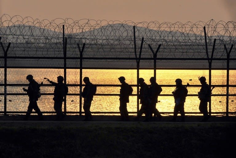 South Korean soldiers patrol along a military fence on the Demilitarized Zone dividing the two Koreas in the border city of Paju on April 26, 2013. Pyongyang, angered by new UN sanctions for its third nuclear test in February and by US-South Korean joint military drills, has issued blistering threats of missile and nuclear attacks targeting the South and the United States