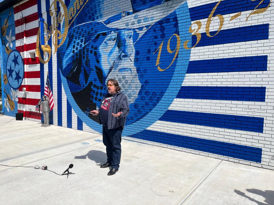 Musician Charlie Daniels son stands in front of a mural depicting his father in Mt. Juliet.