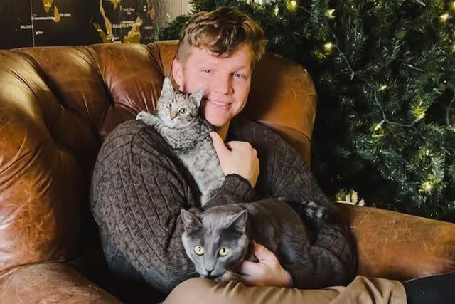 <p>Robert Brown/ Instagram</p> Garrison Brown with two of his cats