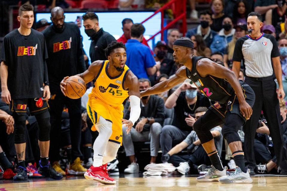 Utah Jazz guard Donovan Mitchell (45) dribbles around Miami Heat forward Jimmy Butler (22) during the first quarter of an NBA game at FTX Arena in Downtown Miami on November 6, 2021.