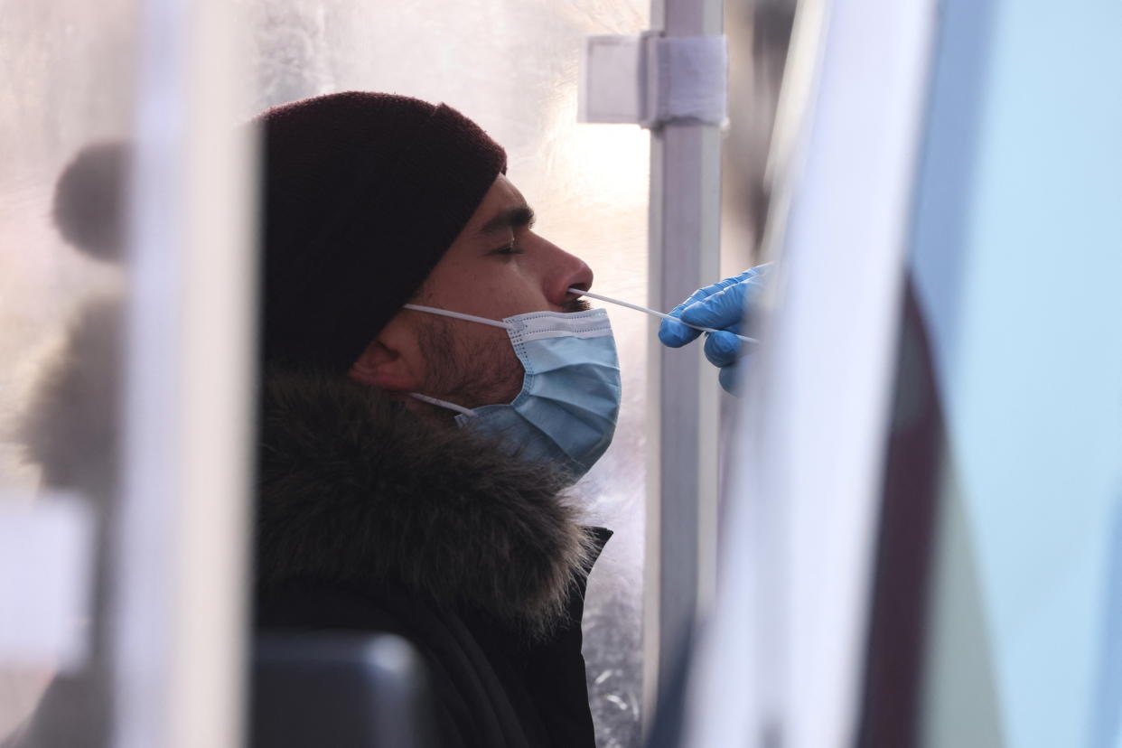 A person is tested for COVID-19  in Times Square as the Omicron coronavirus variant continues to spread in Manhattan, New York City, U.S., December 20, 2021. REUTERS/Andrew Kelly