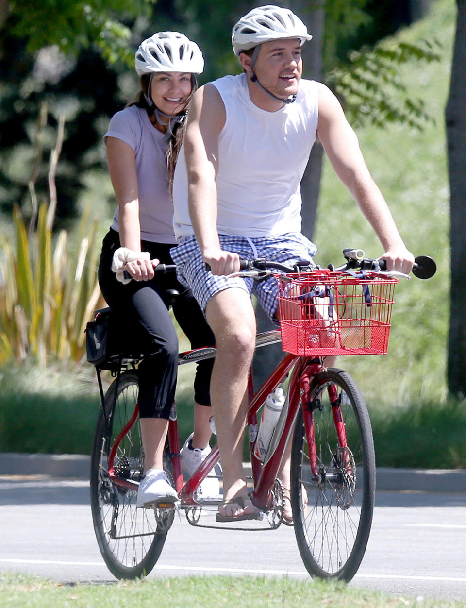 <p>Peter Weber and Kelley Flanagan hop on a tandem bike on Tuesday while hunkered down together in Los Angeles. </p>