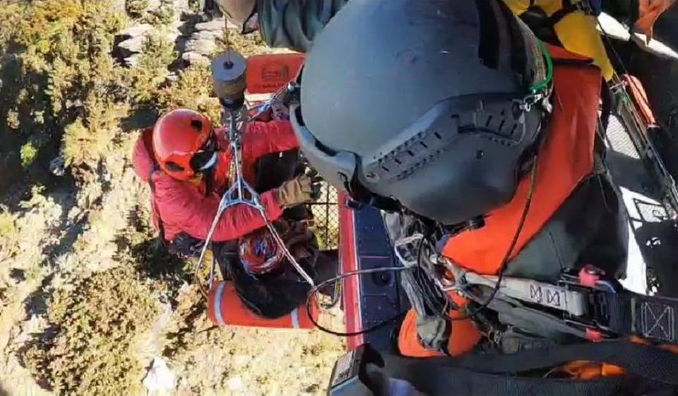 空勤總隊出動直升機，將南投縣仁愛鄉卓社大山女山友吊掛上機送醫。（記者陳金龍翻攝）