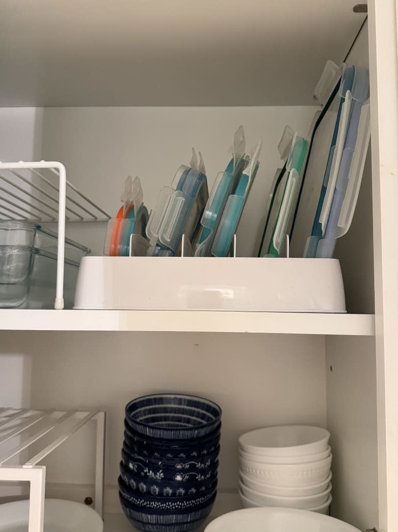 Food storage lids organized in cabinets.