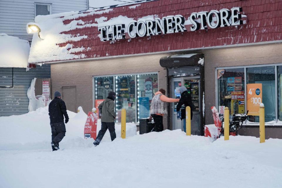 Residents enter a local corner store in Buffalo, New York (AFP via Getty Images)