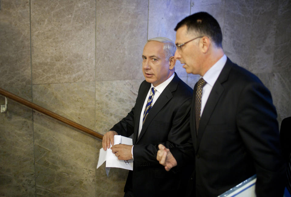 FILE - In this August 26, 2012 file photo, Israeli Prime Minister Benjamin Netanyahu, left, speaks to then Israeli Education Minister Gideon Saar as they arrive to the weekly cabinet meeting in Jerusalem. For years, Saar had been one of Netanyahu’s most loyal and vocal supporters, serving as Cabinet secretary and government minister. Now the telegenic Saar, armed with near unrivaled political savvy and a searing grudge against his former boss, could prove to be Netanyahu’s greatest challenge. (AP Photo/Uriel Sinai/Getty Images, Pool, File)