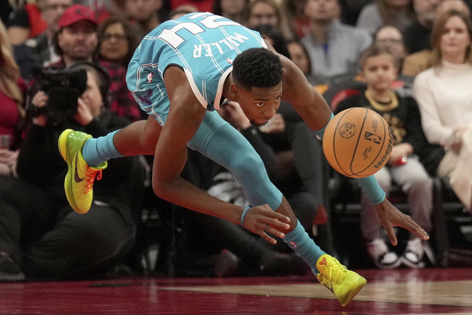 Charlotte Hornets forward Brandon Miller chases the ball during first-half NBA basketball game action against the Toronto Raptors in Toronto, Monday, Dec. 18, 2023. (Nathan Denette/The Canadian Press via AP)