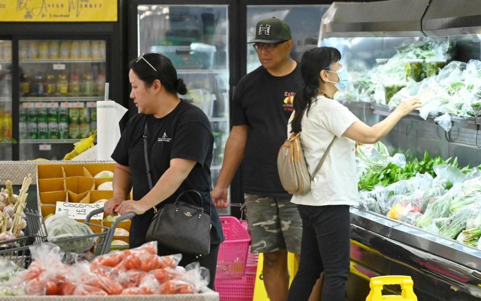 Customers shop the fresh produce at Nubchi Thao’s new business TBL Asian Market, Thursday, June 22, 2023 in Fresno.