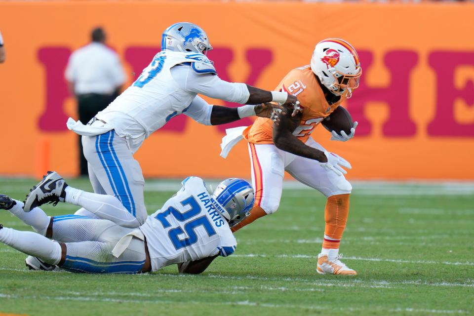 Detroit Lions defensive end Charles Harris (53) and cornerback Will Harris (25) stop Tampa Bay Buccaneers running back Ke'Shawn Vaughn (21) during the first half at Raymond James Stadium in Tampa, Florida, on Sunday, Oct. 15, 2023.