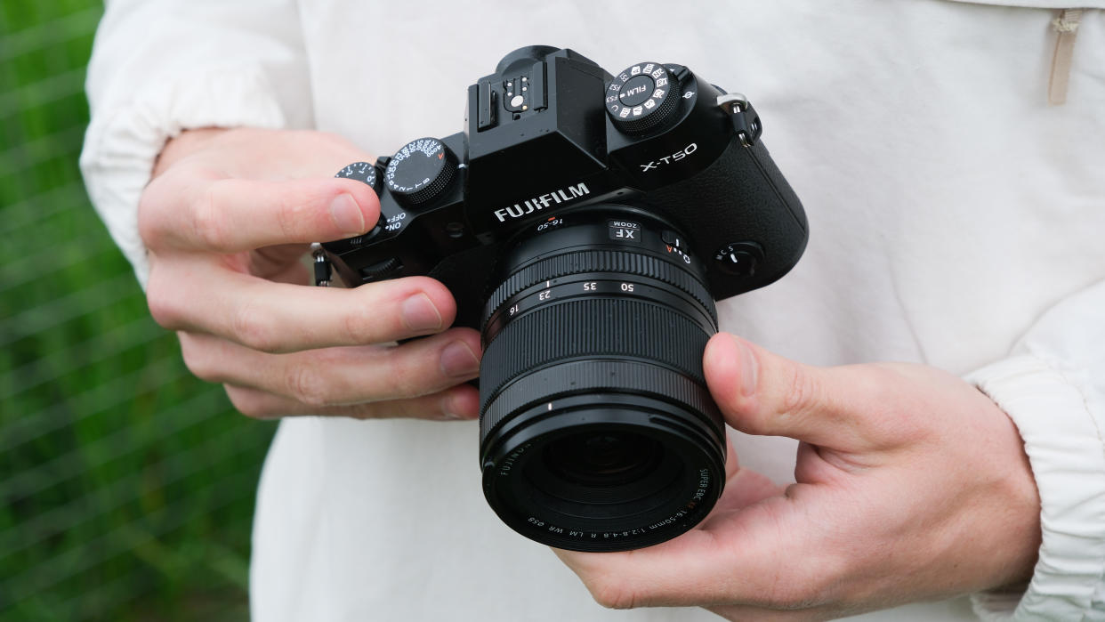  Fujifilm X-T50 camera held in two hands. 