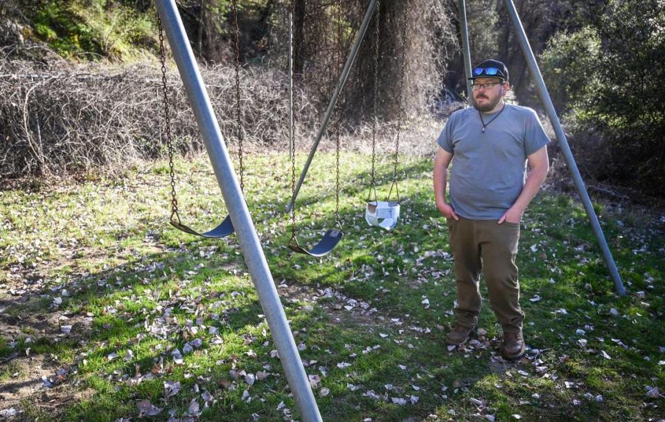 Luke Harbin takes a walk around the playground his father helped build and he played on as a kid in the El Portal Trailer Park near Yosemite National Park on Sunday, March 13, 2022.