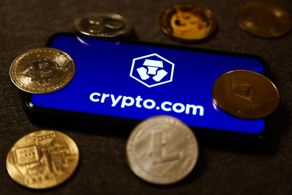 Crypto.com logo displayed on a phone screen and representation of cryptocurrencies are seen in this illustration photo taken in Krakow, Poland on September 28, 2021. (Photo illustration by Jakub Porzycki/NurPhoto via Getty Images)