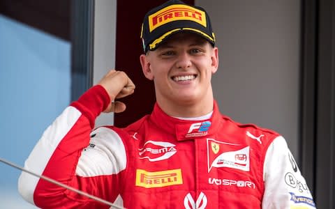 Prema Racing's German driver Mick Schumacher celebrates after winning the Formula Two championship race of the Hungarian Grand Prix at the Hungaroring circuit in Mogyorod near Budapest, Hungary, on August 4, 2019. - Credit: AFP