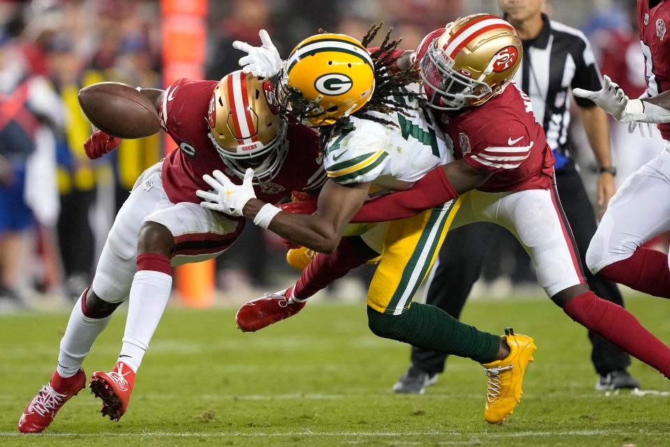 Green Bay Packers wide receiver Davante Adams, middle, cannot catch a pass between San Francisco 49ers cornerback Jimmie Ward, left, and defensive back Emmanuel Moseley during the second half Sunday in Santa Clara, Calif.