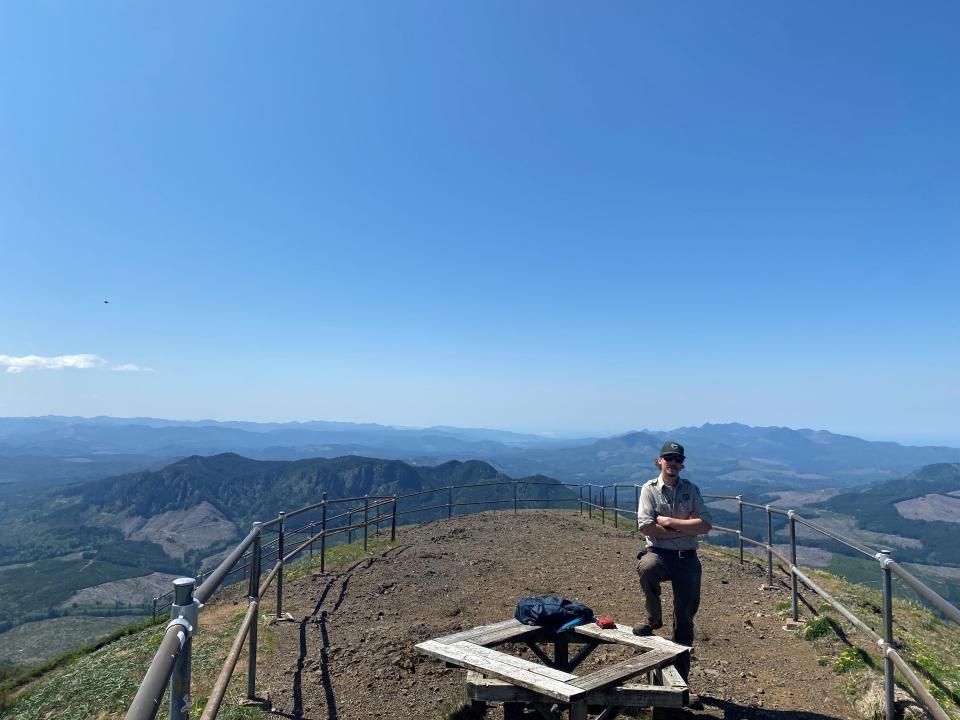 Ranger Eric Crum standing atop the Saddle Mountain summit.