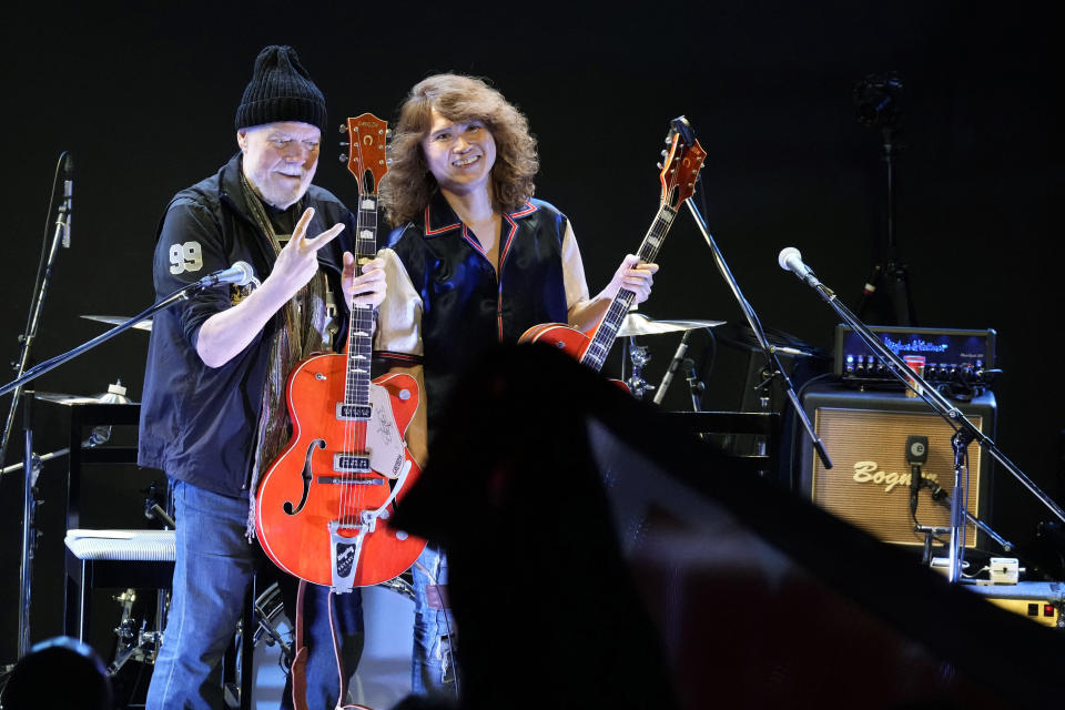 Canadian rock legend Randy Bachman, holding his reunited Gretsch guitar, poses with Japanese musician, TAKESHI during the Lost and Found Guitar Exchange Ceremony Friday, July 1, 2022, at Canadian Embassy in Tokyo. Bachman’s long-held dream came true Friday when he was reunited in Tokyo with a beloved guitar nearly a half-century after it was stolen from a Toronto hotel. Bachman, 78, a former member of The Guess Who, received the guitar from a Japanese musician who had bought it at a Tokyo store in 2014 without knowing its history. (AP Photo/Eugene Hoshiko)