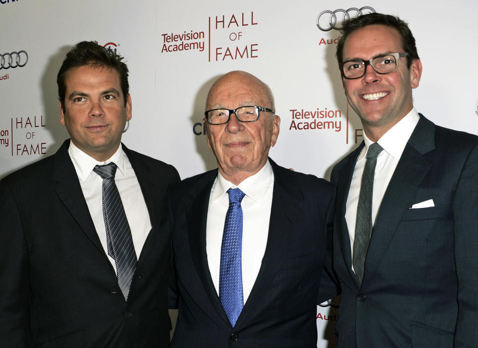 FILE - News Corp. Exeuctive Chairman Rupert Murdoch, center, and his sons, Lachlan, left, and James Murdoch attend the 2014 Television Academy Hall of Fame in Beverly Hills, Calif, March 11, 2014. Media magnate Rupert Murdoch is stepping down as chairman of News Corp. and Fox Corp., the companies that he built into forces over the last 50 years. He will become chairman emeritus of both corporations, the company announced on Thursday. His son, Lachlan, will control both companies. (Photo by Dan Steinberg/Invision/AP Images, File)