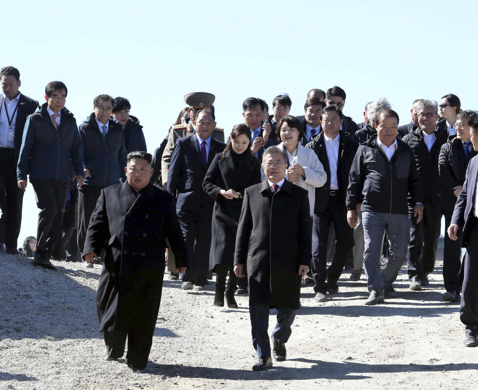 South Korean President Moon Jae-in, front right right, and North Korean leader Kim Jong Un visit Mount Paektu in North Korea, Thursday, Sept. 20, 2018. The two Korean leaders took to the road for the final day of their summit Thursday, heading to a beautiful volcano considered sacred in the North and used in its propaganda to legitimize the Kims' three generations of rule. (Pyongyang Press Corps Pool via AP)