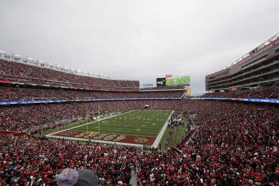 FILE - In this Jan. 19, 2020, file photo, fans at Levi's Stadium watch as the Green Bay Packers kickoff to the San Francisco 49ers during the first half of the NFL NFC Championship football game in Santa Clara, Calif. At a time when America is trying to cope with the financial fallout created by the deadly coronavirus, the renewal of NFL season tickets is not exactly a high priority in the midst of soaring unemployment, business closures and a volatile stock market. Most teams understand this, and have acted accordingly. (AP Photo/Jeff Chiu, File)