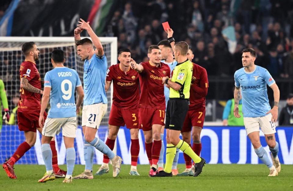 Roma's Roger Ibañez is shown a red card by referee Davide Massa.