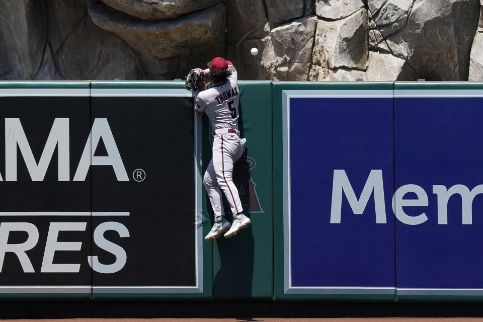 Arizona Diamondbacks center fielder Alek Thomas can't reach a ball hit for a three-run home run by Los Angeles Angels' Mickey Moniak during the second inning of a baseball game Sunday, July 2, 2023, in Anaheim, Calif. (AP Photo/Mark J. Terrill)