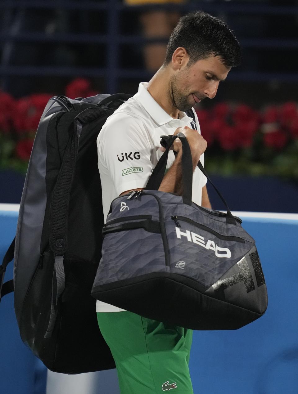 Serbia's Novak Djokovic leaves the court, after he was beaten by Czech Republic's Jiri Vesely during a quarterfinal match of the Dubai Duty Free Tennis Championship in Dubai, United Arab Emirates, Thursday, Feb. 24, 2022. (AP Photo/Kamran Jebreili)