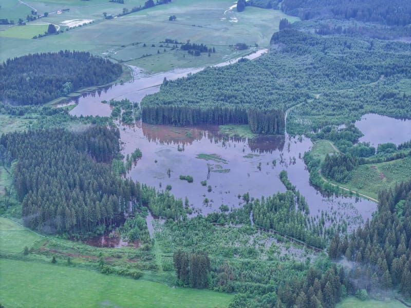 An aerial view of parts of the landscape in the Taufach and Fetzachmoos area have been flooded.  Jason Tschepljakow/dpa