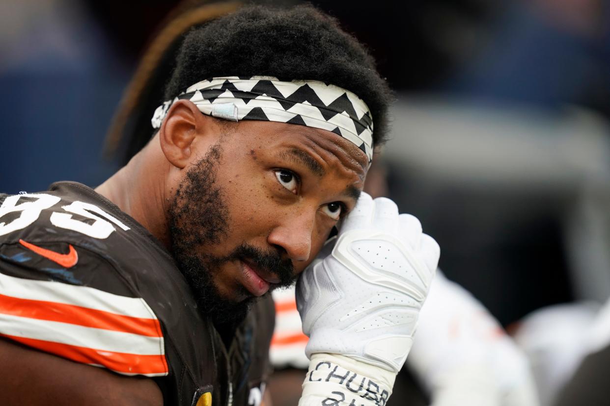 Cleveland Browns defensive end Myles Garrett sits on the sideline with the name of injured running back Nick Chubb written on his wrist during the first half of an NFL football game against the Los Angeles Rams, Sunday, Dec. 3, 2023, in Inglewood, Calif. (AP Photo/Ryan Sun)