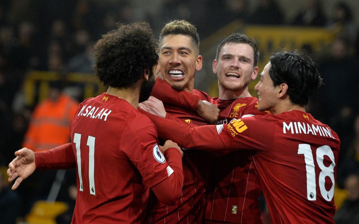 Roberto Firmino celebrates with his teammates after scoring the winner for Liverpool - REX