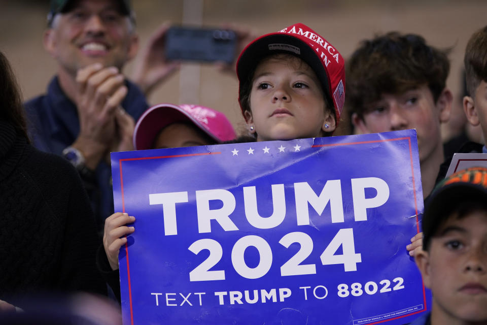 A supporter listens to former President Donald Trump speak during a commit to caucus rally, Saturday, Oct. 7, 2023, in Waterloo, Iowa. (AP Photo/Charlie Neibergall)