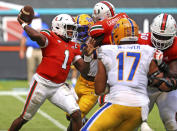 Miami quarterback D'Eriq King (1) passes against Pitts in the second half of an NCAA college football game in Miami Gardens, Fla., Saturday, Oct. 17, 2020. (Al Diaz/Miami Herald via AP)