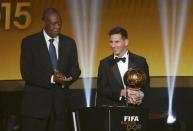 FC Barcelona's Lionel Messi of Argentina receives the FIFA Ballon d'Or 2015 for the world player of the year, as FIFA acting President Issa Hayatou (L) applauds, during an awards ceremony in Zurich, Switzerland, January 11, 2016 REUTERS/Arnd Wiegmann