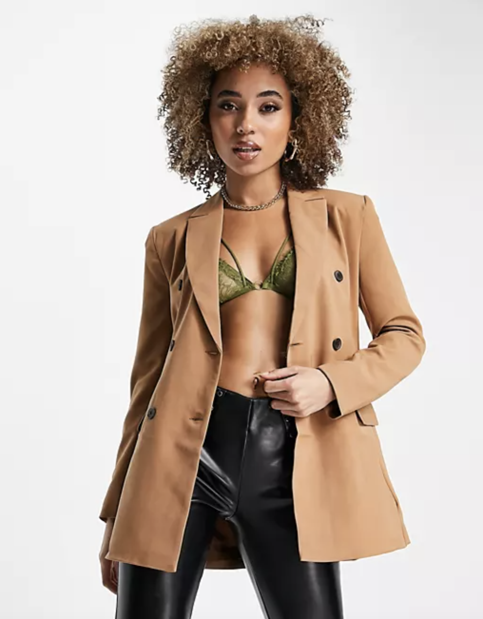 model in green bra, leather pants, and ASOS Design Hourglass Double Breasted Blazer (Photo via ASOS)