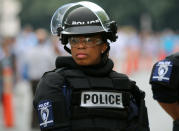 <p>A female police officer wears riot gear as she stands in position outside a football game in Charlotte, N.C., on Sept. 25, 2016. (Mike Blake/Reuters)</p>